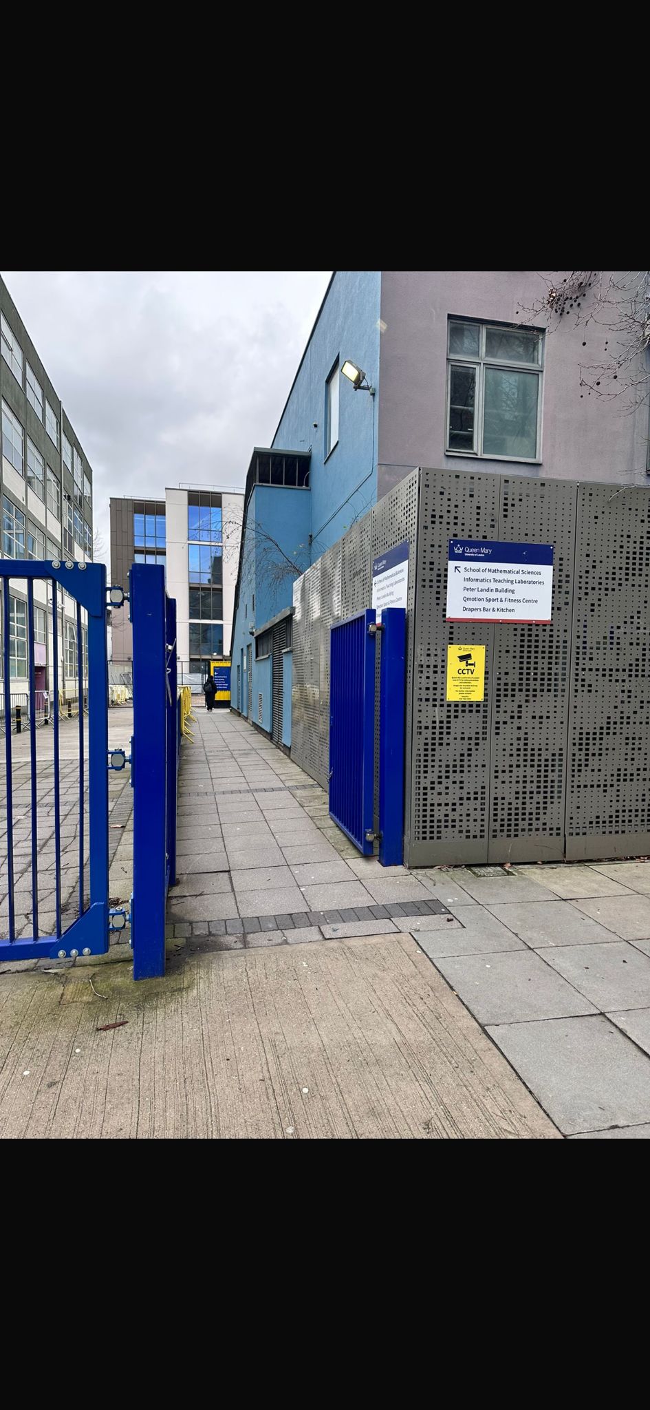 Blue gate and path leading to Qmotion sports centre